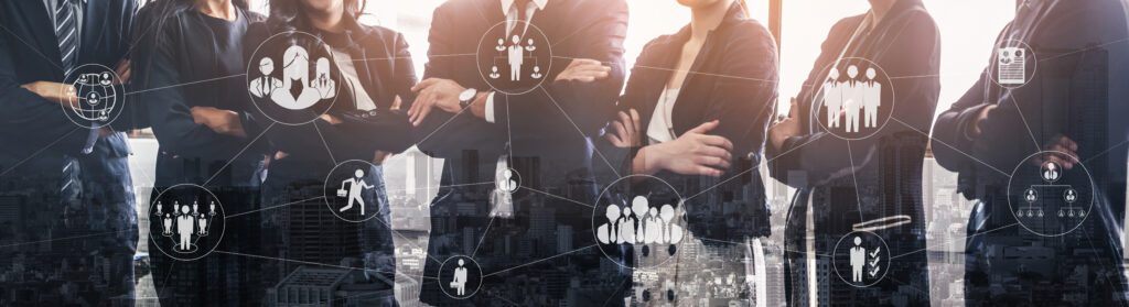 a photo of business men and women standing with their arms folded