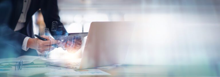 an image of a man at a desk with a laptop in front of him