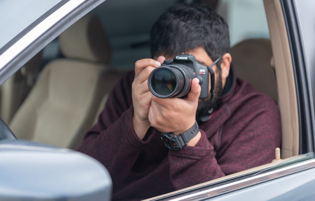 a man in a car with a camera